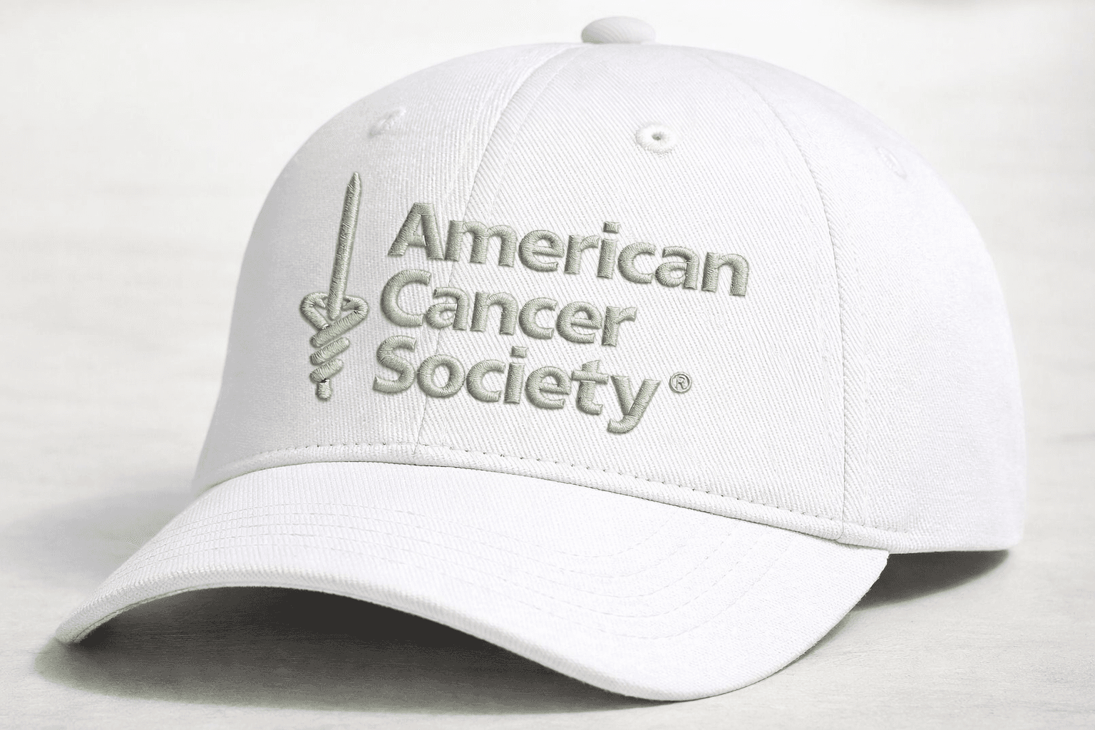 Embroidered logo detail on a finished white cap